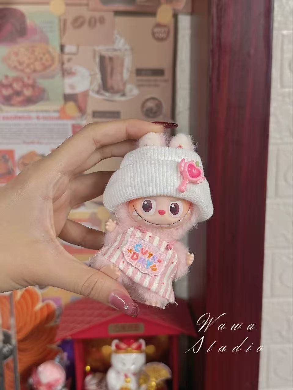 A close-up of a Labubu doll outfit, showing detailed stitching and sustainable fabric