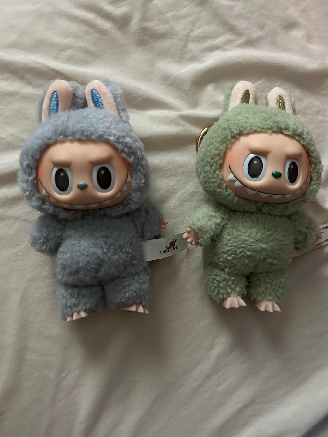 A side-by-side comparison of new and old Labubu plush designs, showing the evolution of the "ugly-cute" aesthetic.