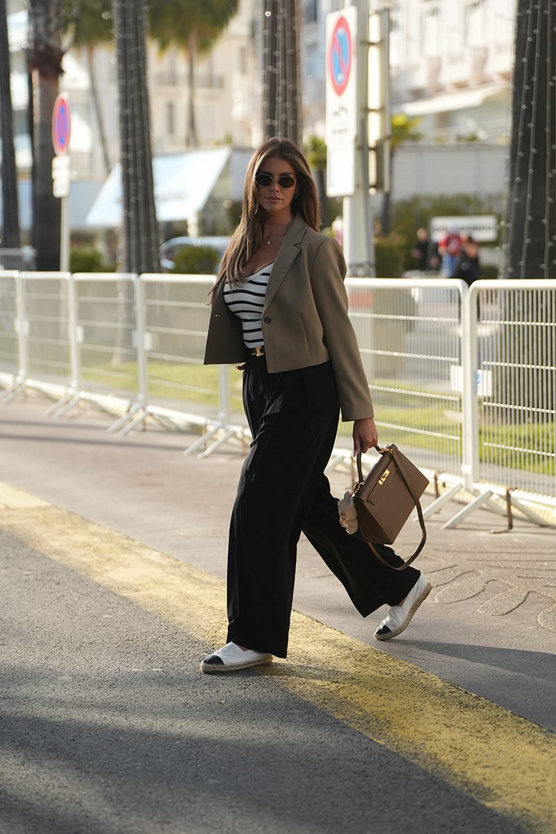 Labubu doll wearing a utility chic outfit with a miniature cargo vest and a functional mini backpack.